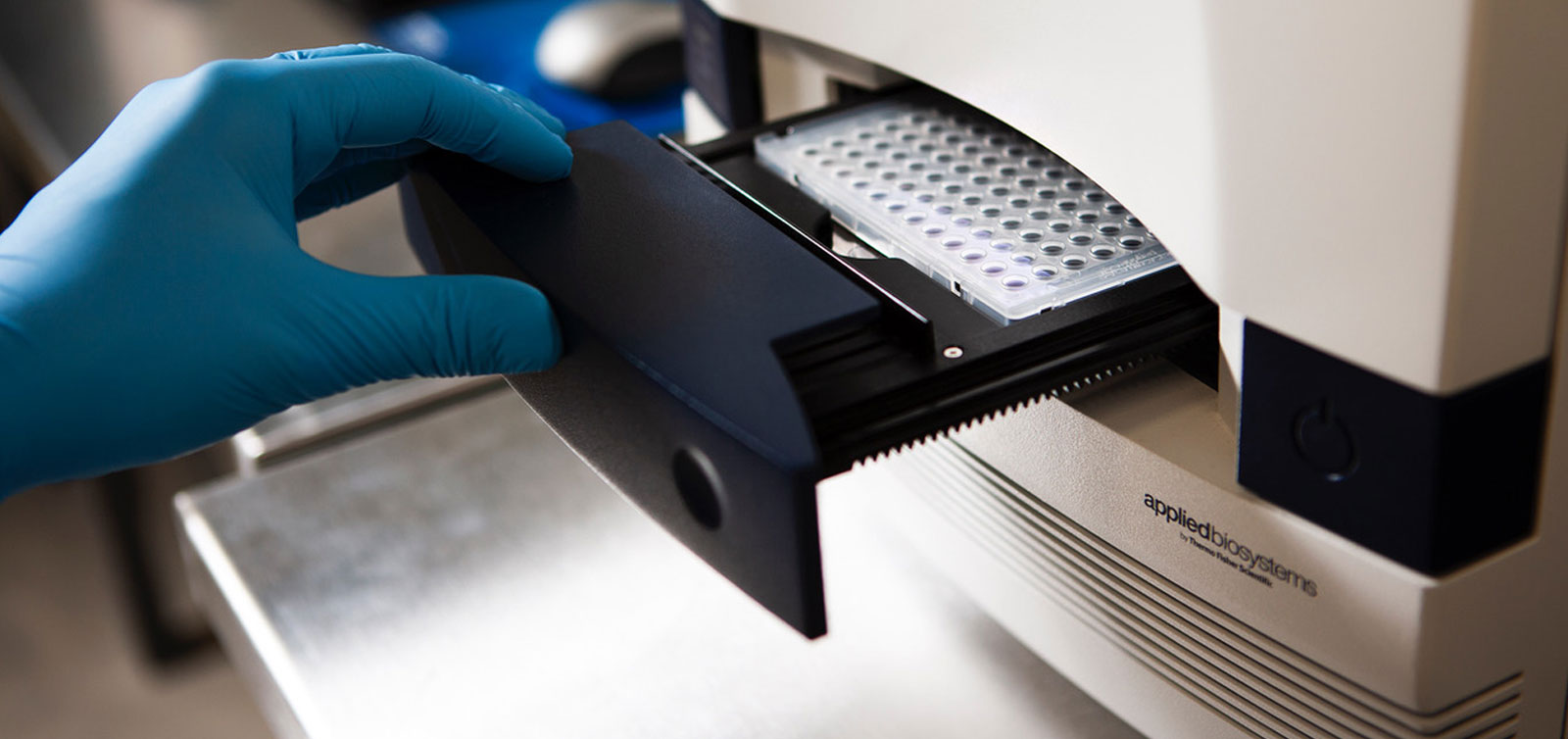 Close-up of an Agilent gas chromatography-mass spectrometry (GC-MS) system in a modern analytical laboratory, showing the autosampler and injection port.
